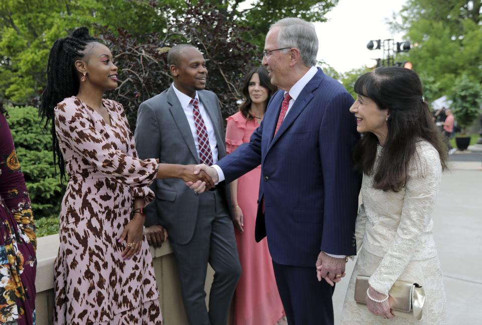 Ayanda Godi shakes hands with Elder Neil L. Andersen, of the Quorum of the Twelve Apostles, as he and his wife Sister Kathy Andersen greet participants in a Face to Face event for single adults age 31 and older on the Logan Utah Temple grounds in Logan on Monday, June 7, 2021. | Kristin Murphy, Deseret News