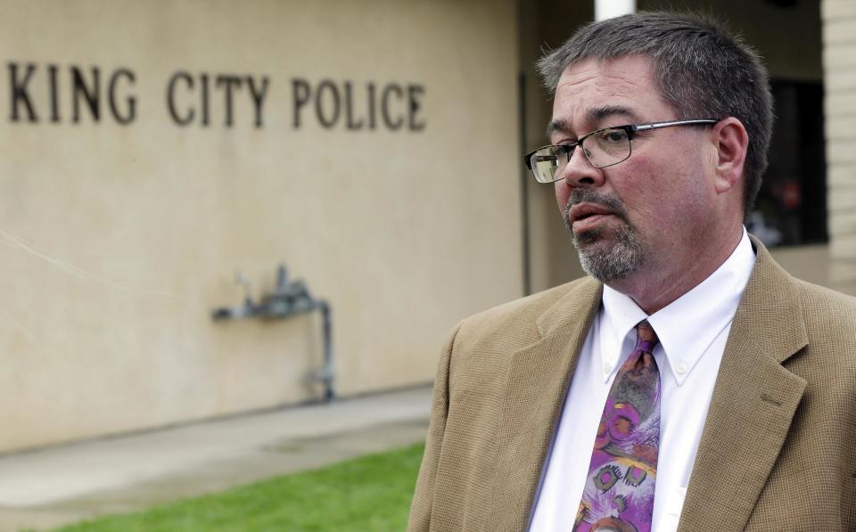 City Manager Michael Powers conducts interviews outside for the police department on Wednesday, Feb. 26, 2014, in King City, Calif. The acting police chief and two officers in King City were removed from duty after being arrested on suspicion of selling or giving away the impounded cars of poor residents, authorities said. Powers told The Associated Press that Monterey County sheriff's deputies and officers from nearby Gonzales and Soledad have volunteered to help the depleted force in King City. (AP Photo/Marcio Jose Sanchez)