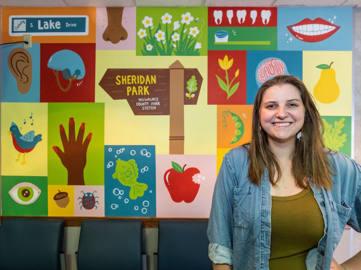 Artist Lauren Marvell stands with a mural she painted in the Cudahy Health Department on Tuesday, August 16, 2022.