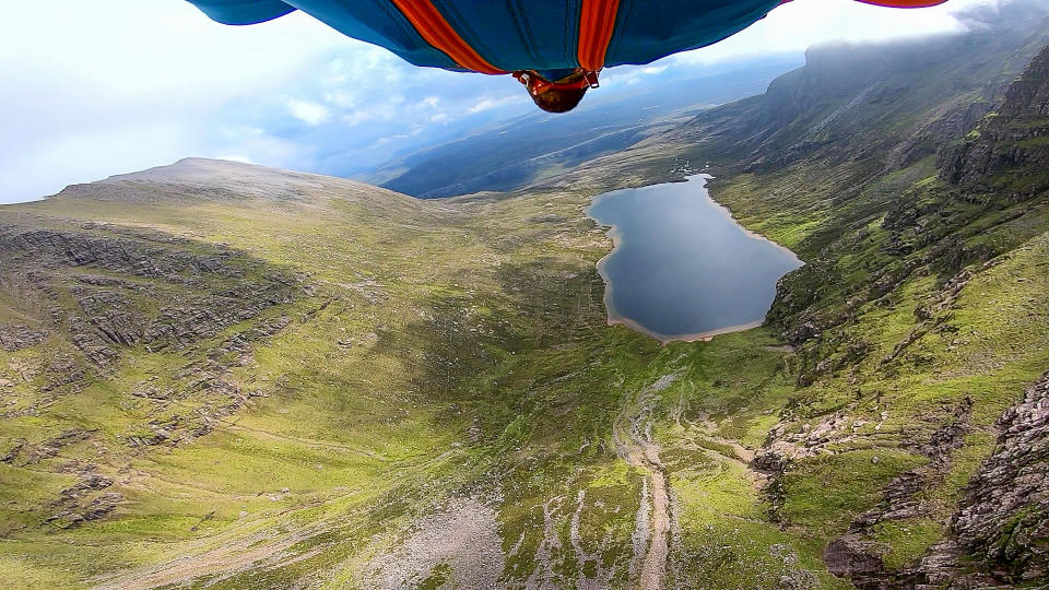 A brave base jumper has become the first person ever to fly a wingsuit from the top of a British mountain. Former Royal Marine Tim Howell, 31, leapt from the 4,000ft peak of An Teallach in the northwest Highlands in Scotland. He plunged down a steep gully for 30 seconds before deploying his parachute and landing safely on the banks of Loch Toll an Lochain.