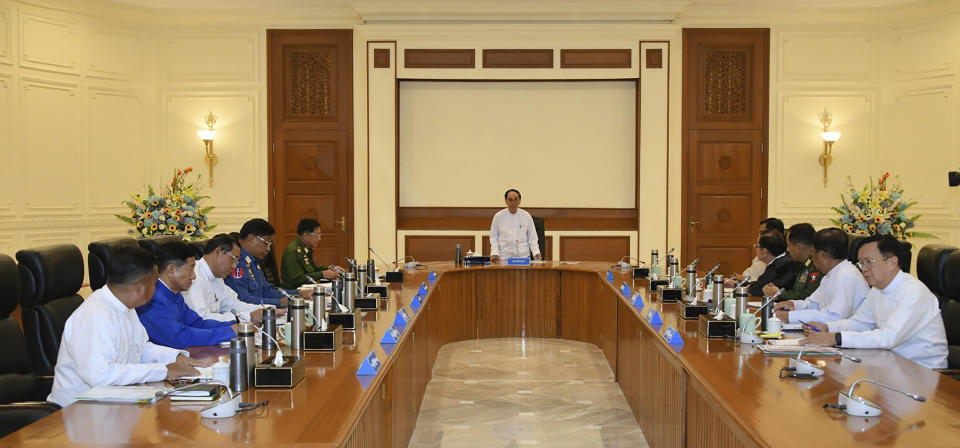 In this photo released from the The Military True News Information Team on Nov.8, 2023, Myint Swe, center, acting President of the military government, speaks during a meeting with members the National Defense and Security Council including Senior Gen. Min Aung Hlaing, center left, chairman of State Administration Council, and Vice President Henry Van Thio, center right, in Naypyitaw, Myanmar. (The Military True News Information Team via AP)