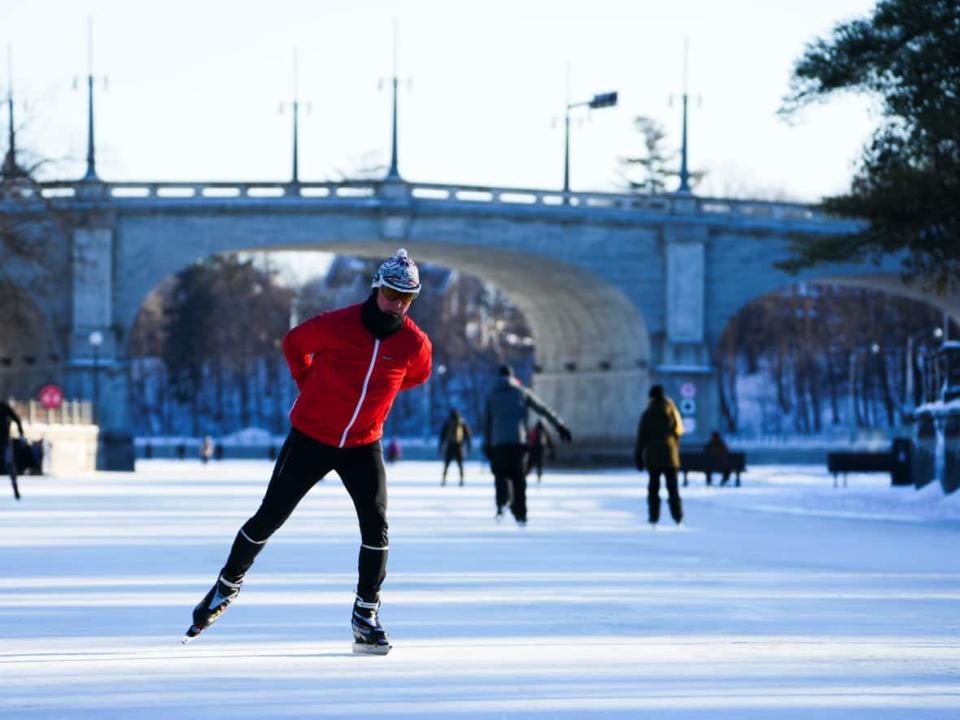 Skaters brave the cold on the opening day of the Rideau Canal Skateway in Ottawa on Friday, Jan. 14, 2022. For the first time in 20 years, the entire length of the skateway was accessible on opening day. (Sean Kilpatrick/The Canadian Press - image credit)