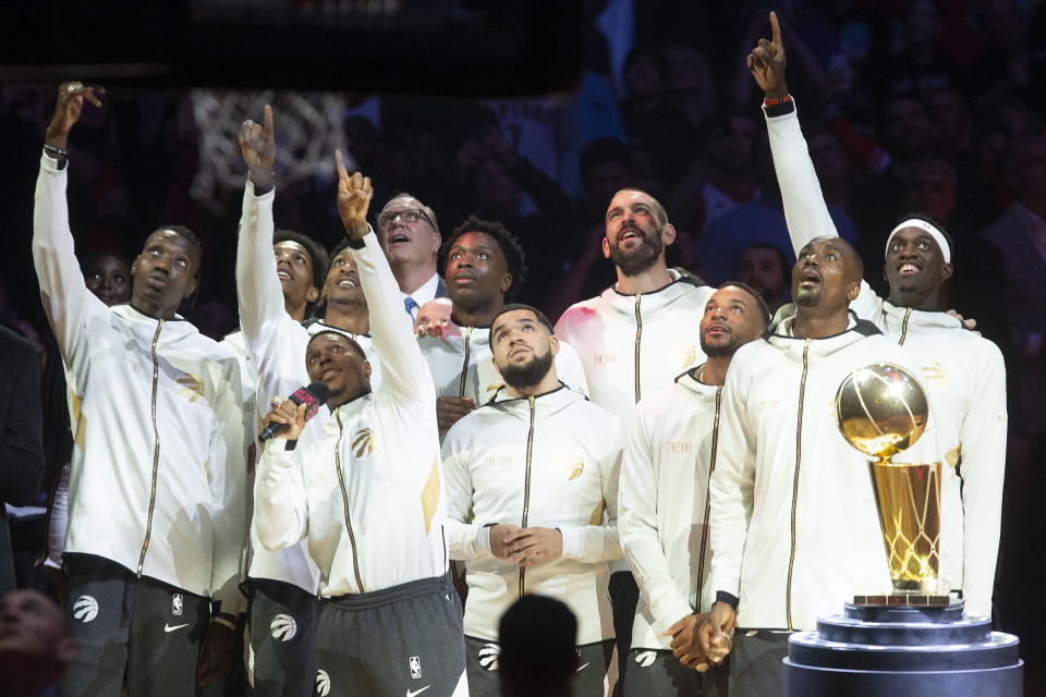 Toronto Raptors watch their 2019 NBA basketball championship pennant being raised before the team's game against the New Orleans Pelican on Tuesday, Oct. 22, 2019, in Toronto. (Chris Young/The Canadian Press via AP)