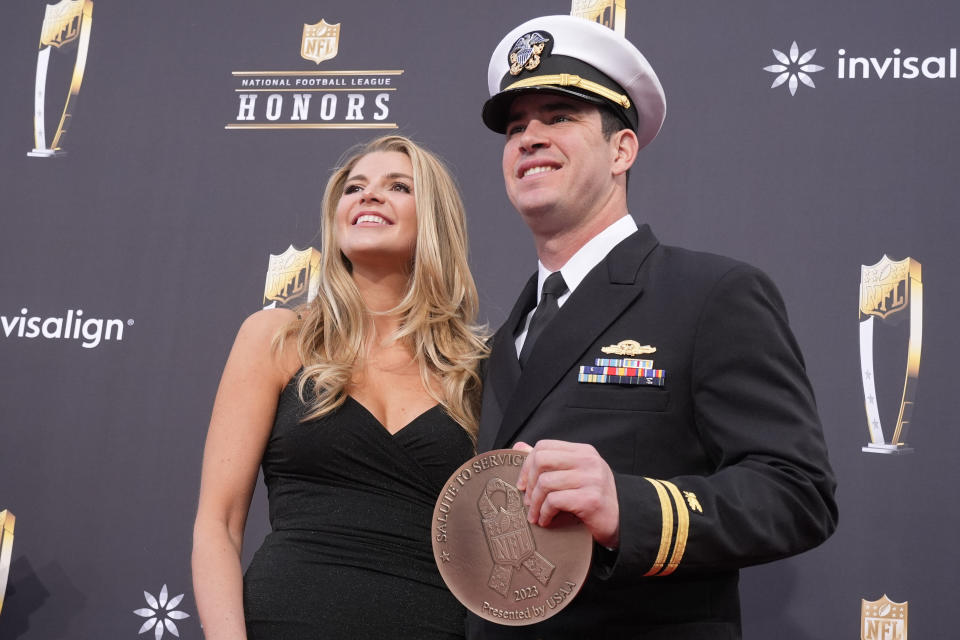 Joseph Cardona, right, of the New England Patriots, right, poses on the red carpet at the NFL Honors award show ahead of the Super Bowl 58 football game Thursday, Feb. 8, 2024, in Las Vegas. The San Francisco 49ers face the Kansas City Chiefs in Super Bowl 58 on Sunday. (AP Photo/Charlie Riedel)