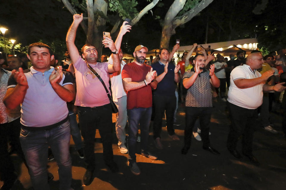 Supporters applaud for Armenian acting Prime Minister Nikol Pashinyan at the headquarters of his party after parliamentary elections in Yerevan, Armenia, Monday, June 21, 2021. Results released Monday showed that the party of Pashinyan won snap parliamentary elections which he called to ease anger over a peace deal he signed with Azerbaijan. (Tigran Mehrabyan/PAN Photo via AP)