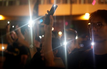 People raise their mobile phones with lights on as they gather at Lennon Wall at Admiralty district during the Mid-Autumn Festival, in Hong Kong
