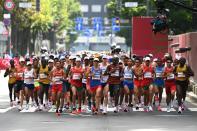 <p>Athletes compete in the men's marathon final during the Tokyo 2020 Olympic Games in Sapporo on August 8, 2021. (Photo by Charly TRIBALLEAU / AFP)</p> 
