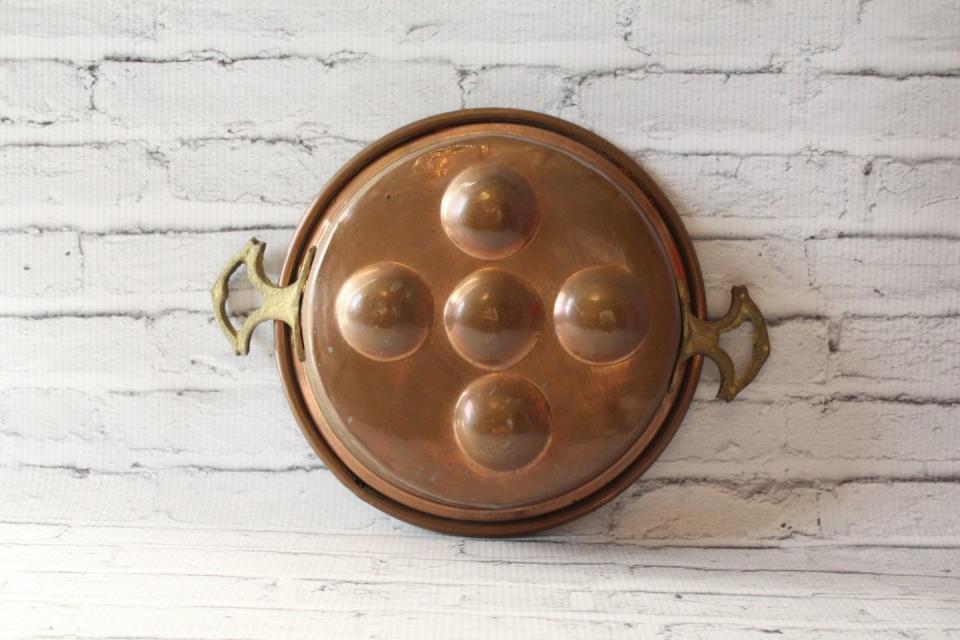 <p>If Grandpa liked his eggs poached, Grandma surely had one of these <a href="https://www.etsy.com/listing/502652337/vintage-copper-egg-poacher-pan-pot" rel="nofollow noopener" target="_blank" data-ylk="slk:pretty pans;elm:context_link;itc:0;sec:content-canvas" class="link ">pretty pans</a>.</p>