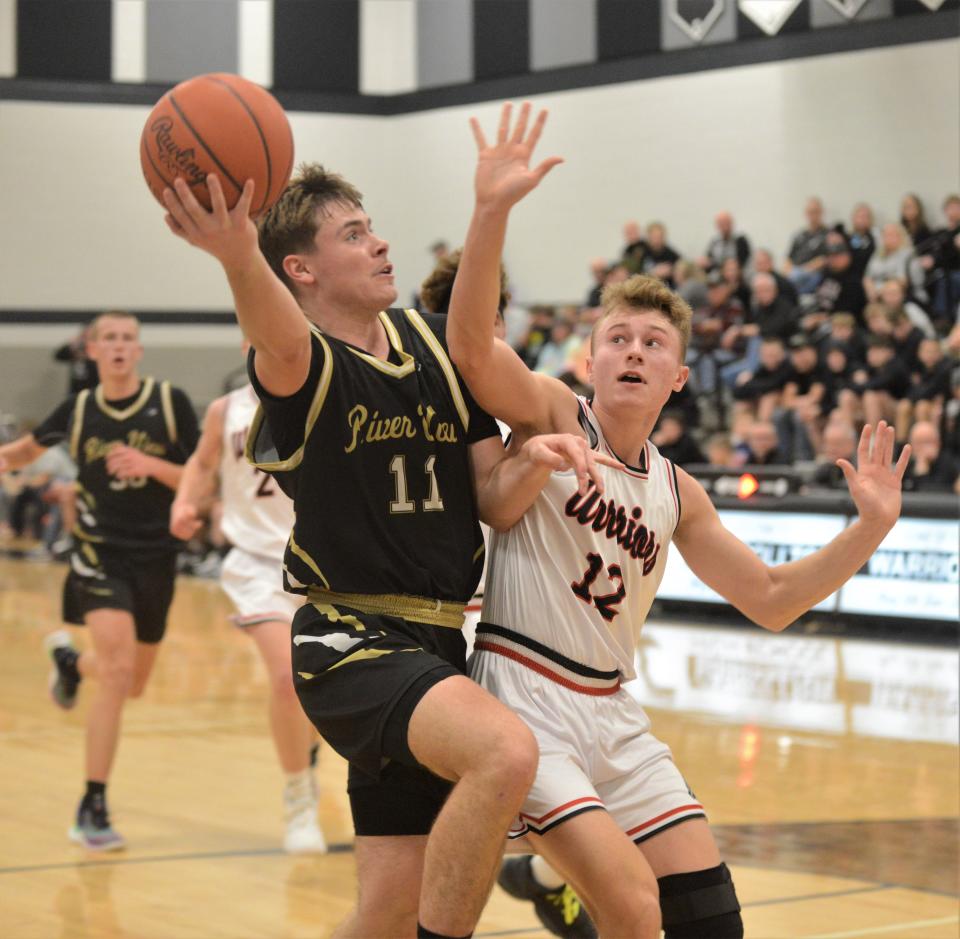 River View's Brody Border goes up for a layup against Carrollton's Jaxon Rinkes in Tuesday's Division II sectional contest. The Warriors won 54-32.