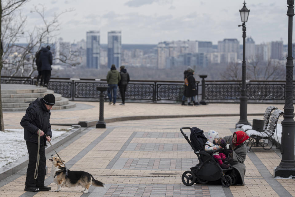 People walk in downtown Kyiv, Ukraine, Sunday, March 12, 2023. (AP Photo/Andrew Kravchenko)