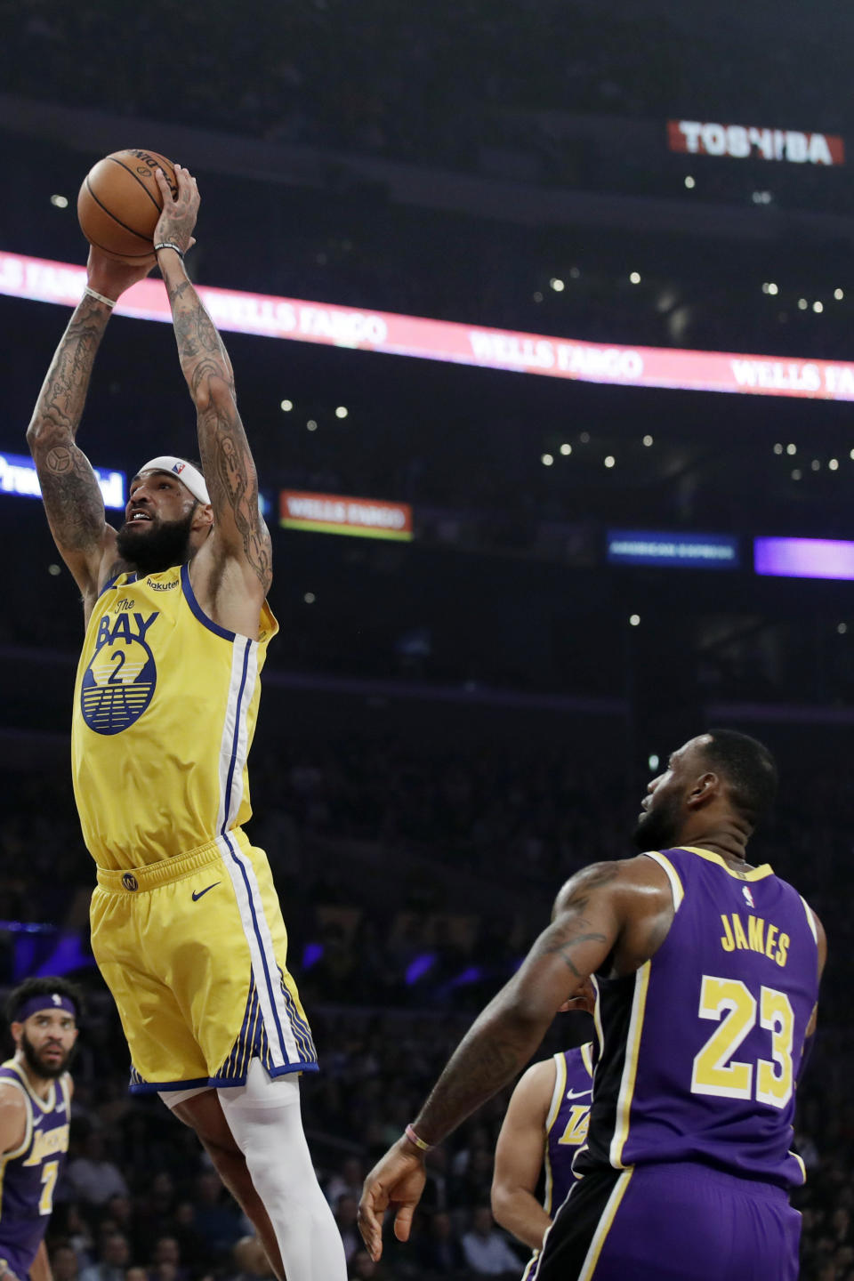 Golden State Warriors' Willie Cauley-Stein (2) dunks past Los Angeles Lakers' LeBron James (23) during the first half of an NBA basketball game Wednesday, Nov. 13, 2019, in Los Angeles. (AP Photo/Marcio Jose Sanchez)