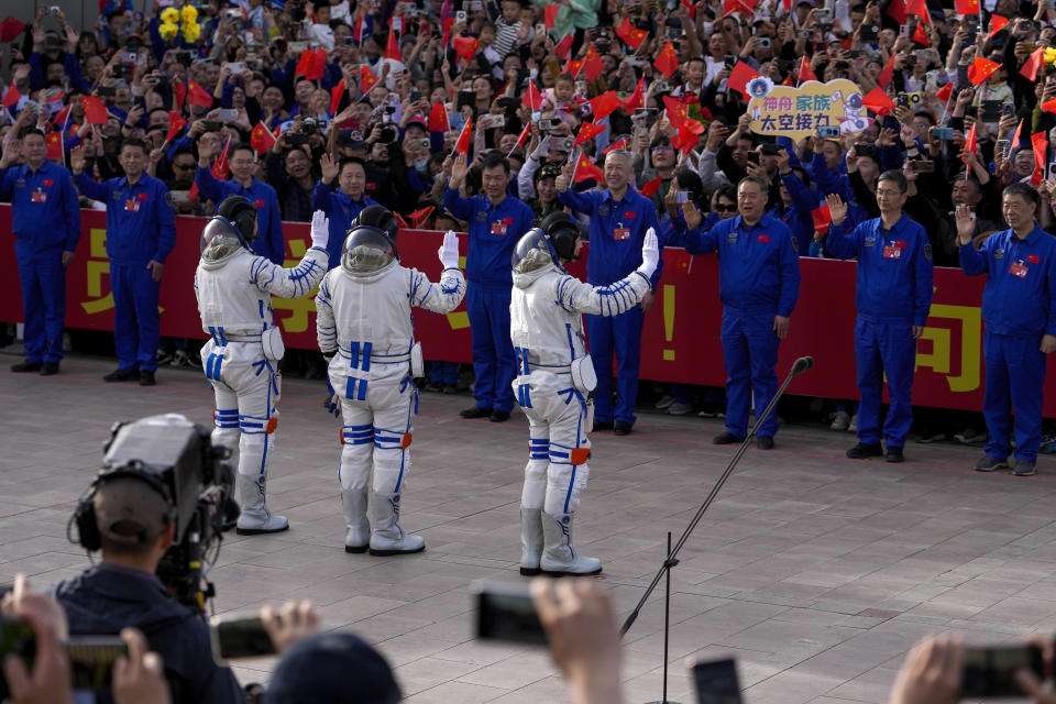 Chinese astronauts for the Shenzhou-18 mission, from left, Li Guangsu, Ye Guangfu and Li Cong wave as they attend a send-off ceremony for their manned space mission at the Jiuquan Satellite Launch Center in northwestern China, Thursday, April 25, 2024. (AP Photo/Andy Wong)