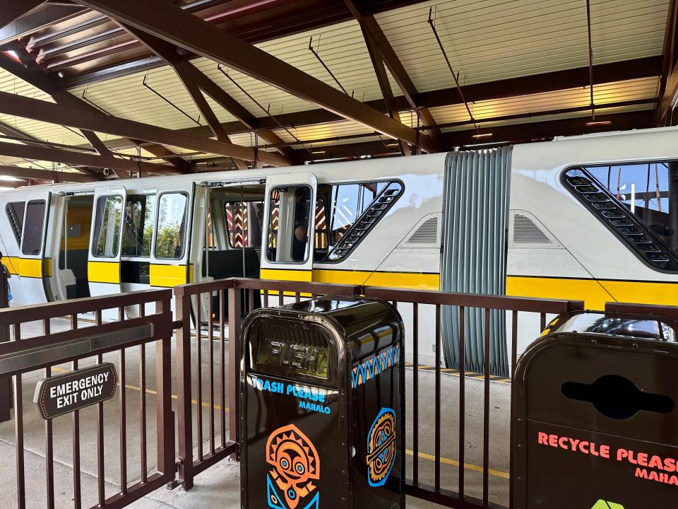 exterior shot of a monorail with its doors opening at disney world