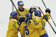 Sweden's Christian Djoos (R) celebrates his goal against Finland with his teammates during the third period of their IIHF World Junior Championship gold medal ice hockey game in Malmo, Sweden, January 5, 2014. REUTERS/Alexander Demianchuk (SWEDEN - Tags: SPORT ICE HOCKEY)