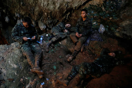 Soldiers take a rest in Tham Luang caves during a search for 12 members of an under-16 soccer team and their coach, in the northern province of Chiang Rai, Thailand, June 27, 2018. REUTERS/Soe Zeya Tun