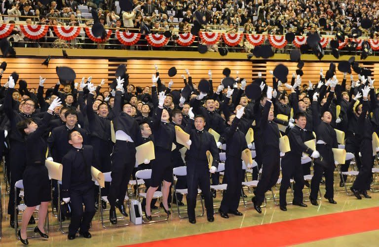 Graduates throw their caps in the air after their graduation ceremony at the National Defense Academy, in Yokosuka, Kanagawa Prefecture, on March 17, 2013. Prime Minister Shinzo Abe urged the graduates to guard against "provocations" amid simmering tensions with China over the sovereigniy of an island chain