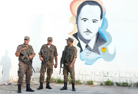 Army soldiers stand guard outside a polling station during presidential election in Tunis