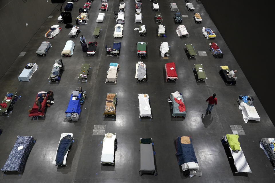 FILE - In this Aug. 11, 2020, file photo, beds fill a homeless shelter inside the San Diego Convention Center in San Diego. A coalition in California is proposing legislation to boost taxes on wealthy multi-national corporations to raise more than $2 billion a year to end homelessness. Supporters say Assembly Bill 71, if approved, would "reinvent" the state's approach to solving homelessness. (AP Photo/Gregory Bull, File)