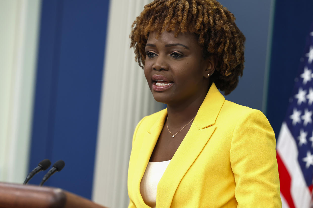 White House press secretary Karine Jean-Pierre stands at a podium.