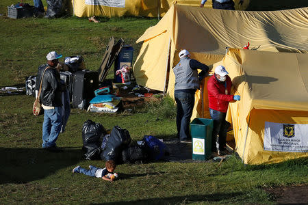 Mayoral workers dismantle tents inside a temporary humanitarian camp that is closed by the government, in Bogota, Colombia January 15, 2019. REUTERS/Luisa Gonzalez