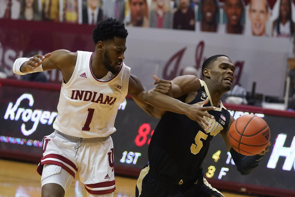 Purdue's Brandon Newman (5) is fouled by Indiana's Al Durham (1) during the first half of an NCAA college basketball game, Thursday, Jan. 14, 2021, in Bloomington Ind. (AP Photo/Darron Cummings)