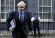 Britain's Prime Minister Boris Johnson walks across Downing Street to attend a Cabinet meeting in London, Tuesday, Oct. 20, 2020. (AP Photo/Kirsty Wigglesworth)