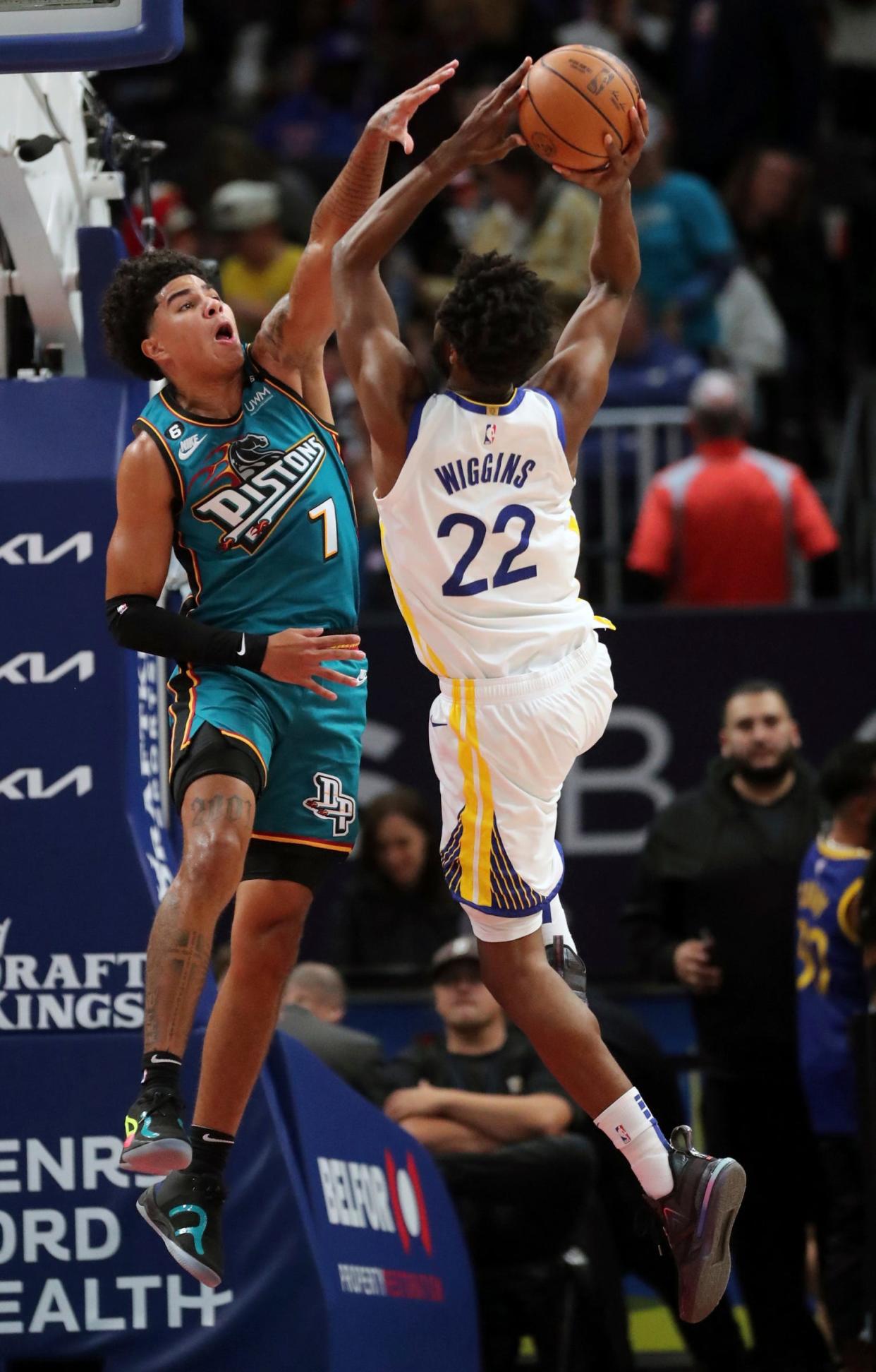 Detroit Pistons guard Killian Hayes (7) defends against  Golden State Warriors forward Andrew Wiggins (22) during second-quarter action at Little Caesars Arena in Detroit on Sunday, Oct. 30, 2022.