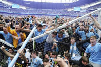 Manchester City fans invade the pitch after their side won the English Premier League following a 3-2 victory over Aston Villa at The Etihad Stadium, Manchester, England, Sunday, May 22, 2022. (Martin Rickett/PA via AP)