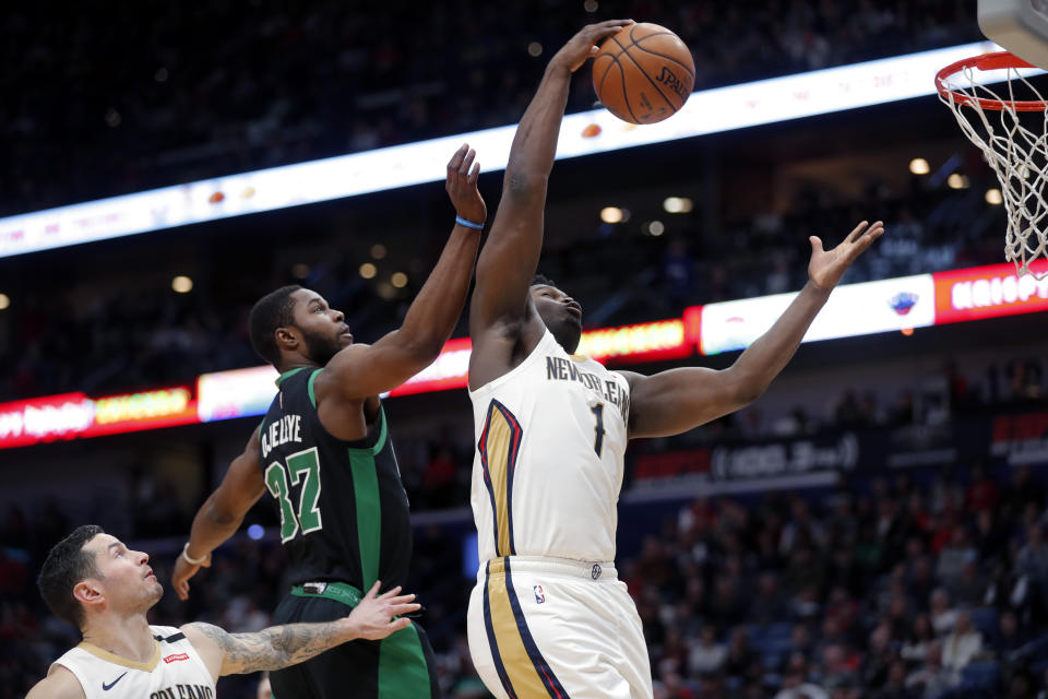 New Orleans Pelicans forward Zion Williamson (1) pulls down rebound against Boston Celtics forward Semi Ojeleye (37) in the second half of an NBA basketball game in New Orleans, Sunday, Jan. 26, 2020. The Pelicans won 123-108. (AP Photo/Gerald Herbert)