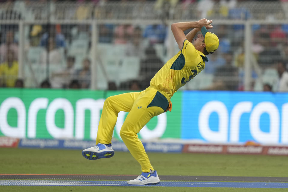 Australia's captain Pat Cummins takes the catch to get South Africa's Quinton De Kock dismissed during the ICC Men's Cricket World Cup second semifinal match between Australia and South Africa in Kolkata, India, Thursday, Nov. 16, 2023. (AP Photo/Mahesh Kumar A.)