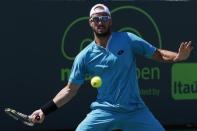 Viktor Troicki hits a forehand against Kei Nishikori (not pictured) on day eight of the Miami Open at Crandon Park Tennis Center. Nishikori won 6-2, 6-2. Mandatory Credit: Geoff Burke-USA TODAY Sports