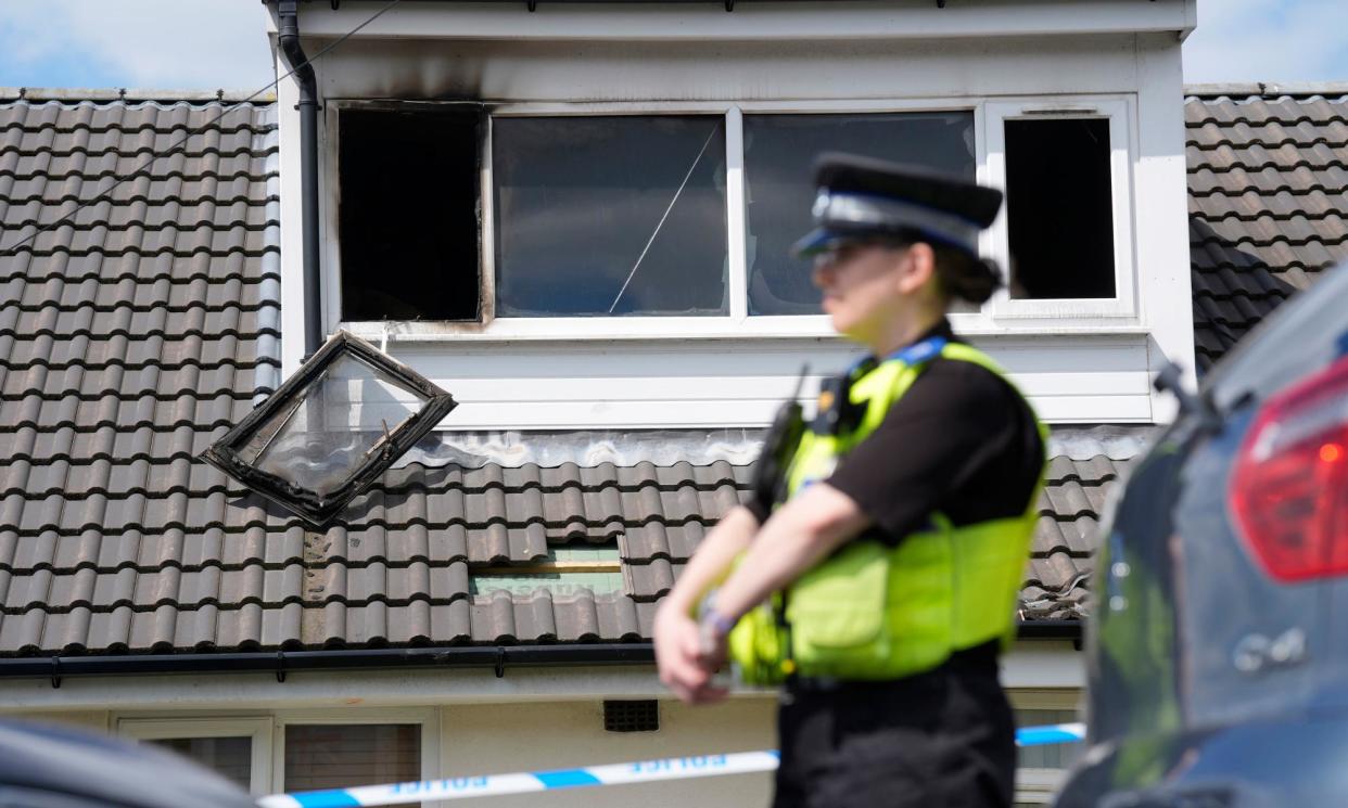 <span>A police officer at the scene of the house fire in Bradford.</span><span>Photograph: Danny Lawson/PA</span>