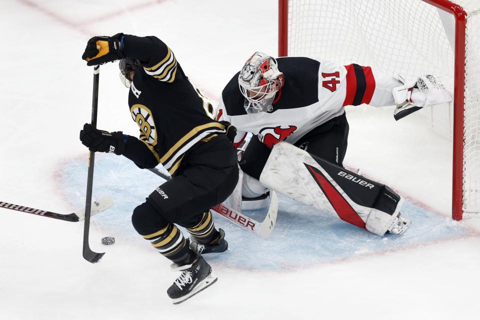 Boston Bruins' David Pastrnak tries to get a shot on New Jersey Devils' Vitek Vanecek (41) during the first period of an NHL hockey game Saturday, Dec. 30, 2023, in Boston. (AP Photo/Michael Dwyer)