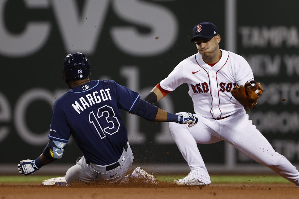 Boston Red Sox's Jose Iglesias turns to tage Tampa Bay Rays' Manuel Margot, who was out trying to stretch a single into a double during the fourth inning of a baseball game Wednesday, Sept. 8, 2021, at Fenway Park in Boston. (AP Photo/Winslow Townson)