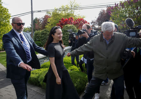 FILE PHOTO: Huawei's Financial Chief Meng Wanzhou leaves her family home flanked by private security in Vancouver, British Columbia, Canada, May 8, 2019. REUTERS/Lindsey Wasson/File Photo