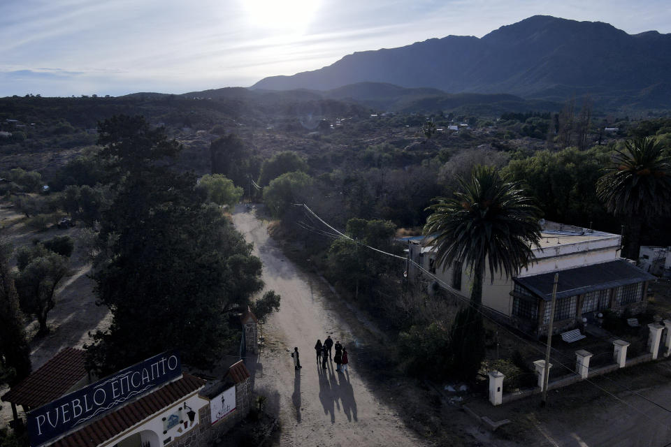 A group of Brazilian tourists arrive to the Pueblo Encanto spiritual theme park in Capilla del Monte, Argentina, Wednesday, July 19, 2023. In the pope’s homeland of Argentina, Catholics have been renouncing the faith and joining the growing ranks of the religiously unaffiliated. Commonly known as the “nones,” they describe themselves as atheists, agnostics, spiritual but not religious, or simply: “nothing in particular.” (AP Photo/Natacha Pisarenko)