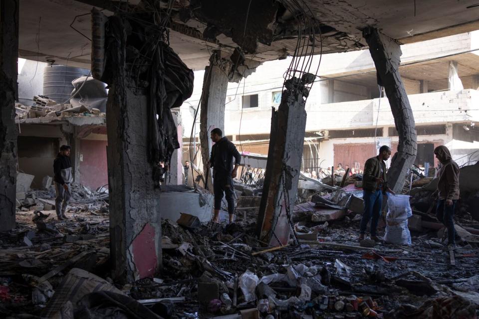 Palestinians check destruction after an Israeli strike in Rafah, Gaza Strip, on Saturday, Feb. 24, 2024.