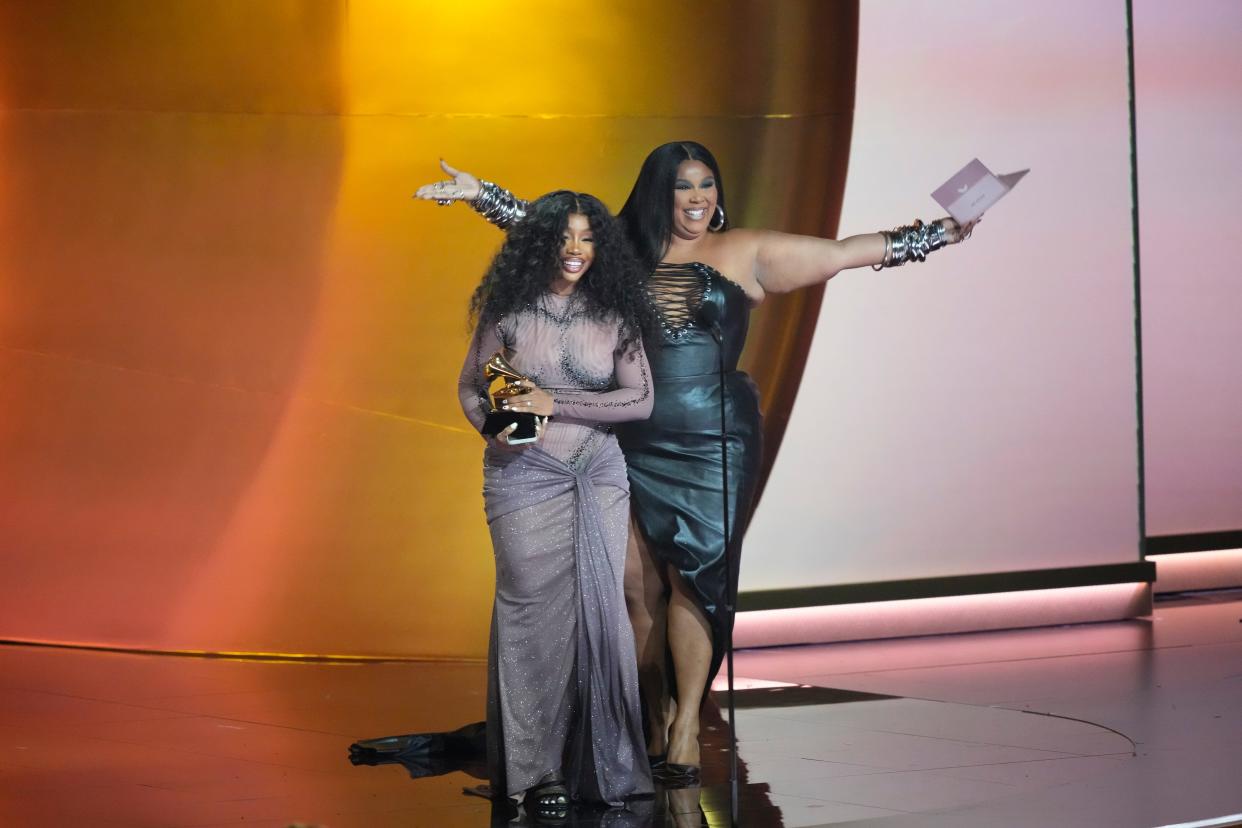 SZA, front, accepts the award for best R&B song from Lizzo.