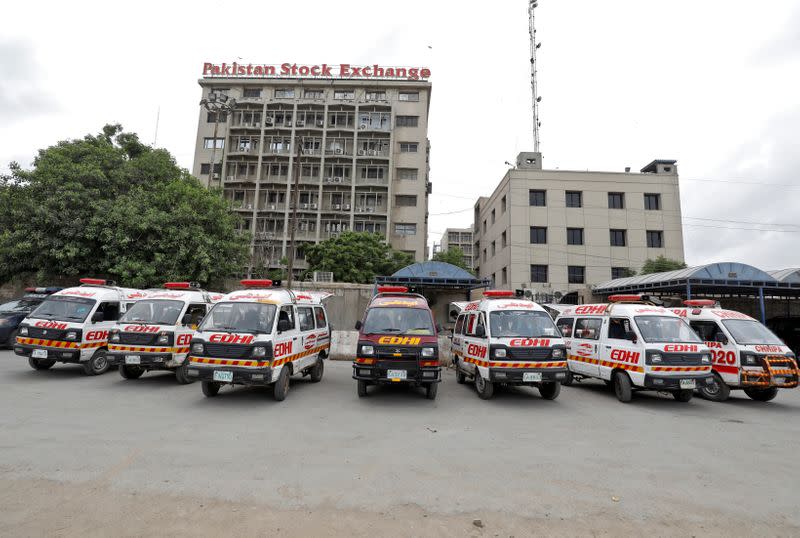 Ambulances are seen parked outside Pakistan Stock Exchange building after an attack in Karachi