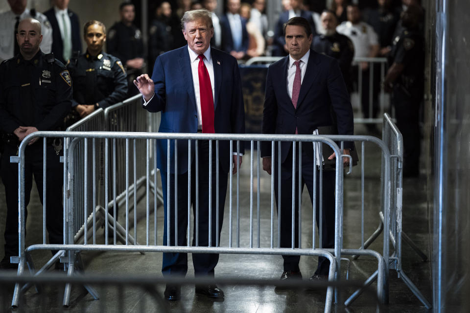 Former President Donald Trump, left, with his attorney Todd Blanche, speaks to reporters outside of the courtroom following the first day of jury selection for his trial at the Manhattan criminal court in New York, on Monday, April 15, 2024. (Jabin Botsford/The Washington Post via AP, Pool)