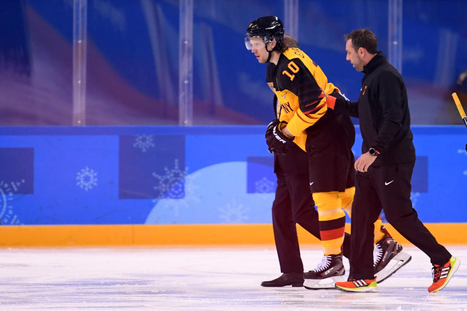 Christian Ehrhoff is helped off the ice during Germany’s qualification game against Switzerland in PyeongChang, South Korea on Tuesday. (Getty)