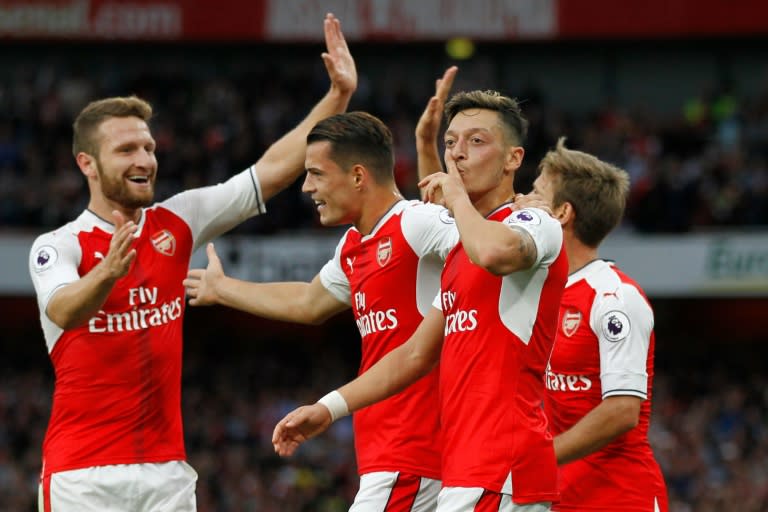 Arsenal's German midfielder Mesut Ozil celebrates scoring their third goal against Chelsea