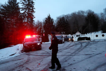 Police vehicles are seen outside the home of former U.S. President Bill Clinton and former Democratic presidential candidate Hillary Clinton after firefighters were called to put out a fire at the property in Chappaqua, New York, U.S., January 3, 2018. REUTERS/Mike Segar