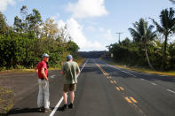 <p>Mark Clawson, 64, (L), and Tom McCarroll, 68, look at a lava flow near their homes outskirts of Pahoa during ongoing eruptions of the Kilauea Volcano in Hawaii, June 6, 2018. (Photo: Terray Sylvester/Reuters) </p>