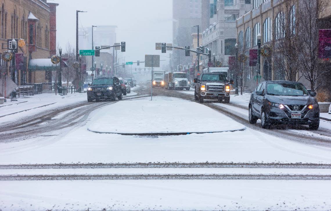 Snow accumulates on W. Bannock St. and N. Capitol Blvd. in downtown Boise on Wednesday, Dec. 29, 2021.