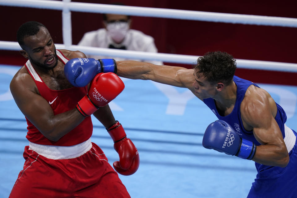 New Zealand's David Nyika, right, lands a punch to Youness Baalla, of Morocco, during their heavy weight (91kg) preliminary boxing match at the 2020 Summer Olympics, Tuesday, July 27, 2021, in Tokyo, Japan. (AP Photo/ Frank Franklin II)