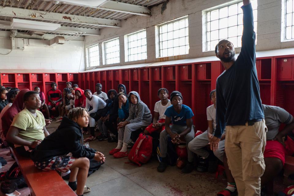 Members of the West Side Cubs 12U football team listen to coach Lamar Robinson while watching film as they prepare for an upcoming game during practice at McCabe Field in Detroit on Tuesday, September 12, 2023. More than just youth football and cheerleading teams, the West Side Cubs represent a vital community institution with a 66-year history.