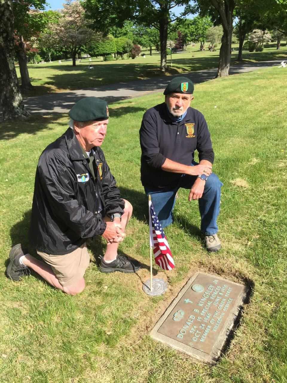 Special Forces veterans John Hardman and Tom Duffney kneel by the just-tended gravestone of fallen Green Beret Donald Kingsley at Highland Memorial Park Cemetery in Johnston.