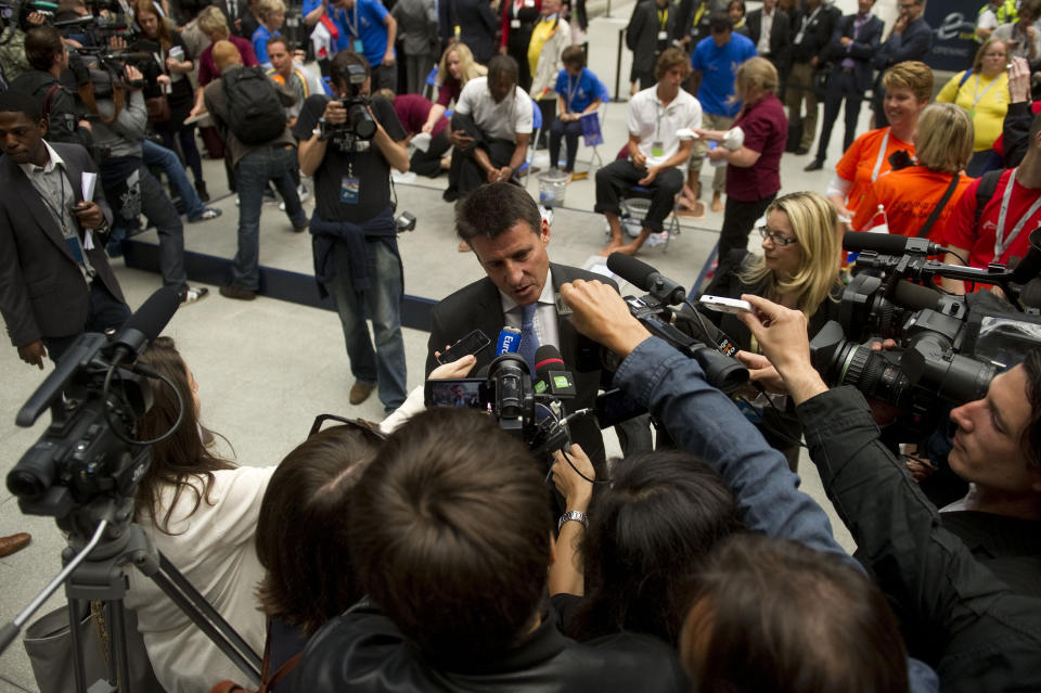 Lord Sebastian Coe (C), Chairman of the London 2012 Organising Committee, speaks to the media at St Pancras International Station in central London, on July 27, 2011. The one-year countdown to the 2012 Olympics got under way on Wednesday with officials bullishly predicting London was on course to deliver the best ever games with 12 months to go. International Olympic Committee chief Jacques Rogge was set to extend a formal invitation to the world's athletes during a 7:00pm ceremony at Trafalgar Square in the culmination of day-long events to mark the one-year milestone. AFP PHOTO / CARL COURT (Photo credit should read CARL COURT/AFP/Getty Images)