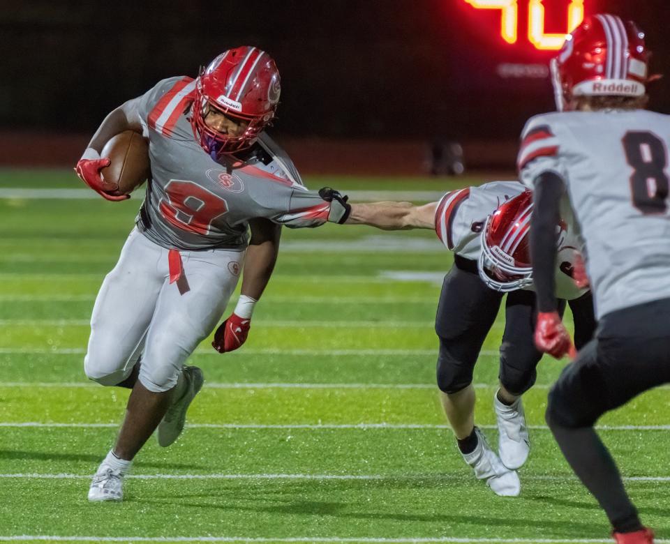 Canton South’s Rome Cox is slowed down by Struthers’ NaJier Howard on Friday, Nov. 17, 2023.